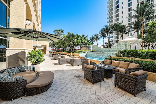 view of patio featuring an outdoor living space with a fire pit