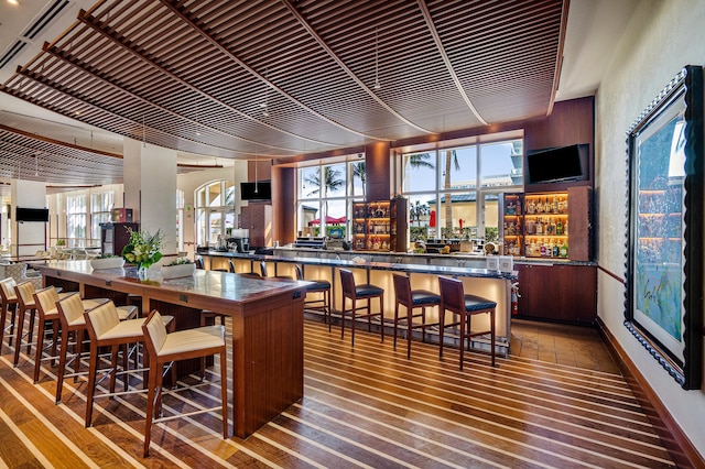 bar with hardwood / wood-style flooring