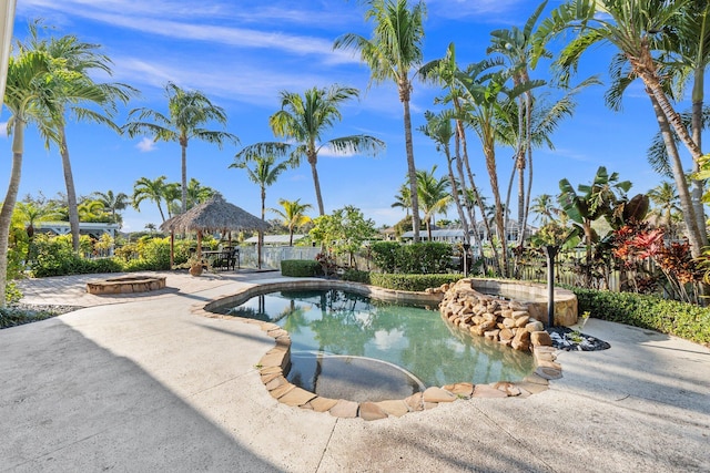 view of swimming pool featuring a gazebo, an in ground hot tub, and a patio area