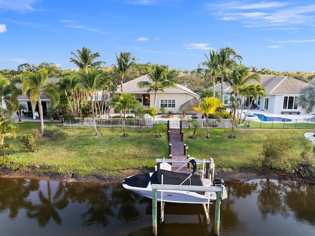 dock area featuring a water view and a lawn