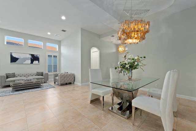 tiled dining room with an inviting chandelier