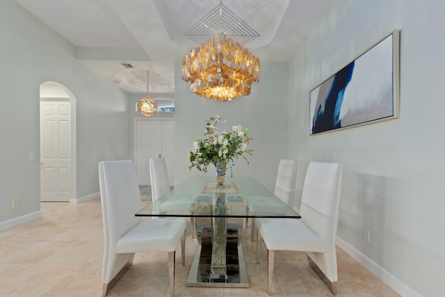 tiled dining room with an inviting chandelier