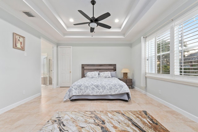 tiled bedroom featuring connected bathroom, ceiling fan, and a tray ceiling