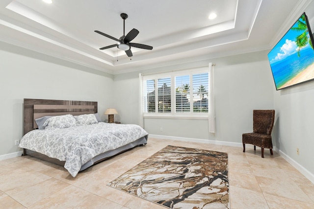 bedroom with ceiling fan and a raised ceiling