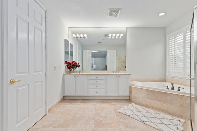 bathroom with vanity, tile patterned floors, and independent shower and bath