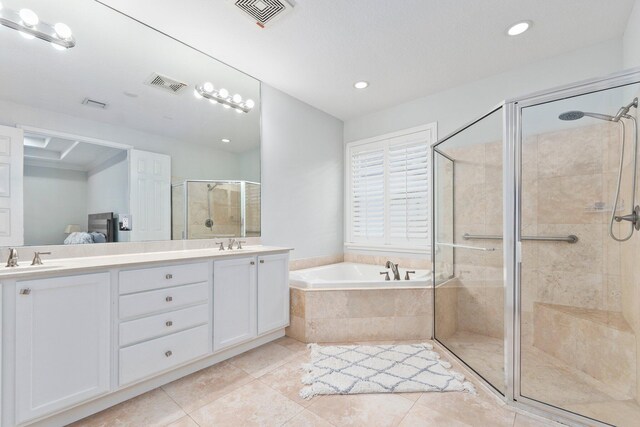 bathroom featuring vanity, tile patterned floors, and shower with separate bathtub