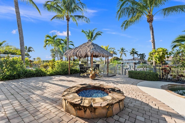 view of home's community with a gazebo, a patio, and an outdoor fire pit