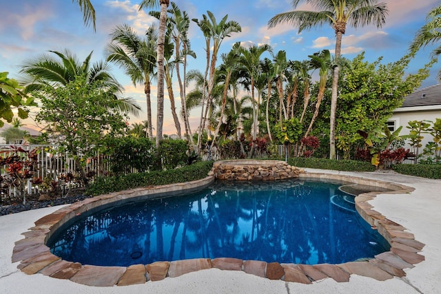 view of pool at dusk