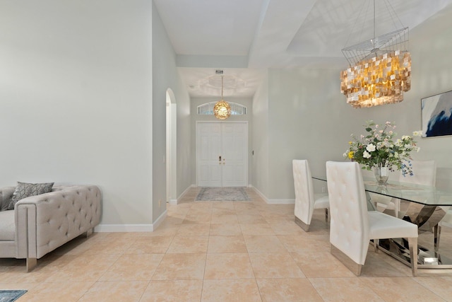 tiled foyer with a chandelier