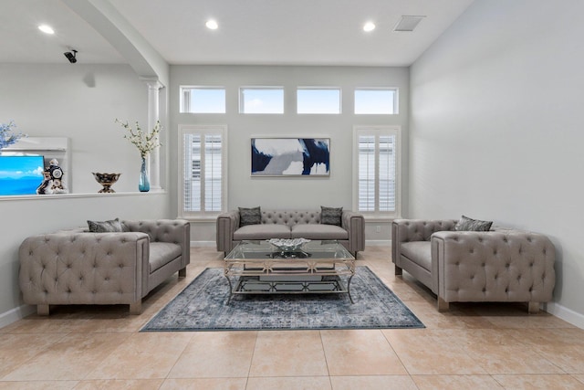 tiled living room featuring ornate columns