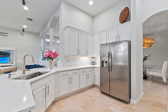 kitchen featuring white cabinetry, stainless steel fridge with ice dispenser, and sink