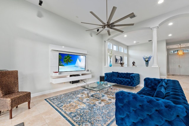 living room with ceiling fan, light tile patterned floors, and ornate columns