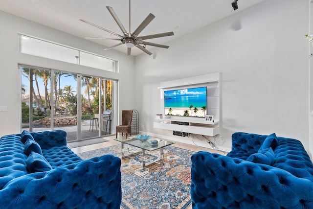 living room featuring a towering ceiling and ceiling fan