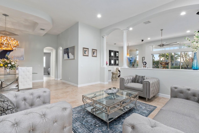 tiled living room with ceiling fan and decorative columns