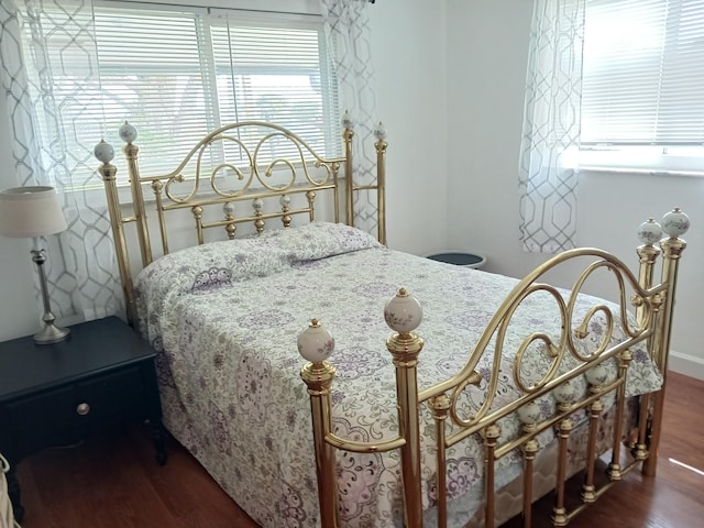 bedroom with dark wood-style flooring