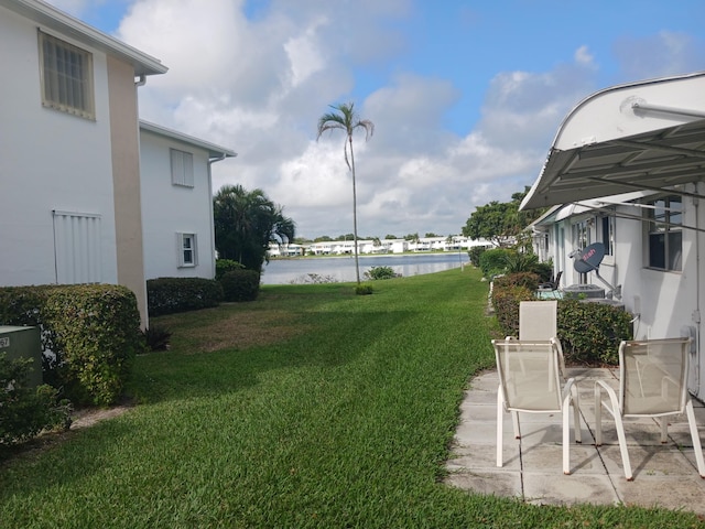 view of yard with a patio area and a water view