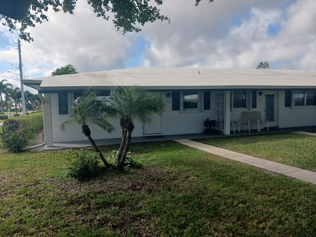 ranch-style house with a front lawn