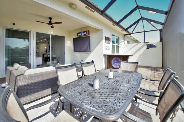 24031 SW Firenze Way, Port Saint Lucie, FL 34986 - view of patio / terrace with outdoor lounge area, outdoor dining space, a lanai, and a ceiling fan