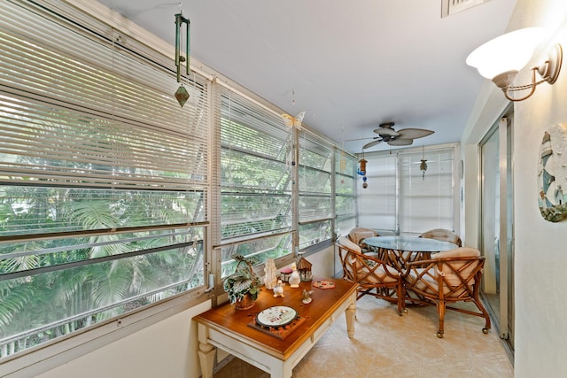 sunroom featuring ceiling fan