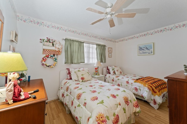 bedroom with ceiling fan and light hardwood / wood-style flooring