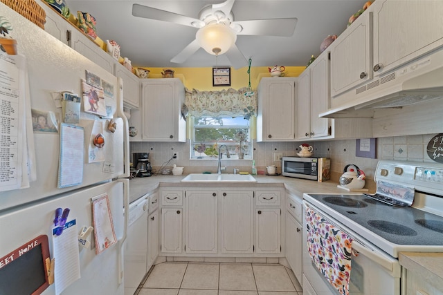 kitchen featuring white cabinetry, sink, light tile patterned floors, and white appliances