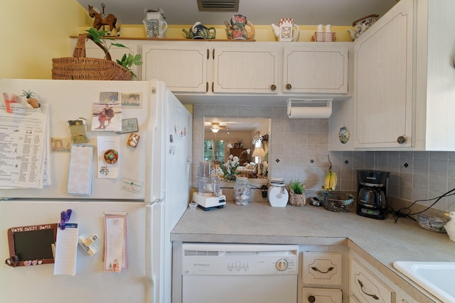 kitchen with tasteful backsplash, sink, and white appliances