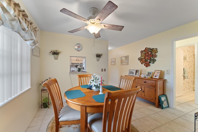 tiled dining space featuring ceiling fan