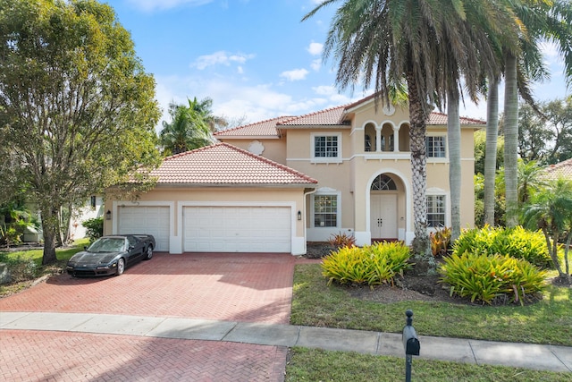 mediterranean / spanish house featuring a garage