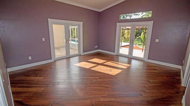 empty room featuring ornamental molding, dark wood-type flooring, vaulted ceiling, and french doors