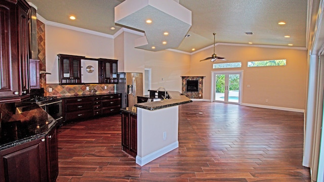 14717 11th Ter, Loxahatchee Groves, FL 33470 - kitchen with stainless steel fridge, gas range, ceiling fan, dark wood-style flooring, and crown molding