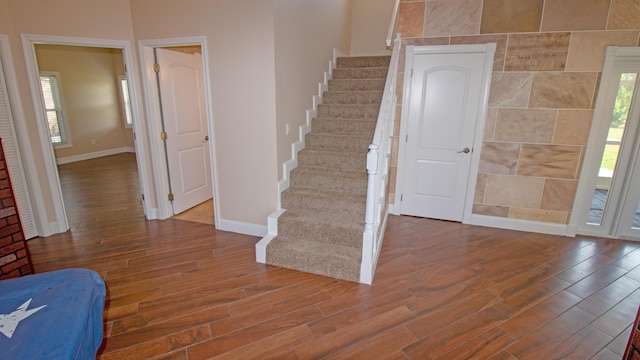 staircase with hardwood / wood-style flooring and plenty of natural light