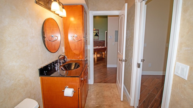 14717 11th Ter, Loxahatchee Groves, FL 33470 - bathroom featuring wood finished floors, vanity, baseboards, and toilet