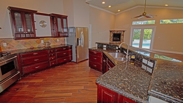 kitchen with hardwood / wood-style floors, appliances with stainless steel finishes, sink, ornamental molding, and decorative backsplash