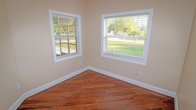 unfurnished room with wood-type flooring