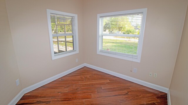 spare room with hardwood / wood-style floors