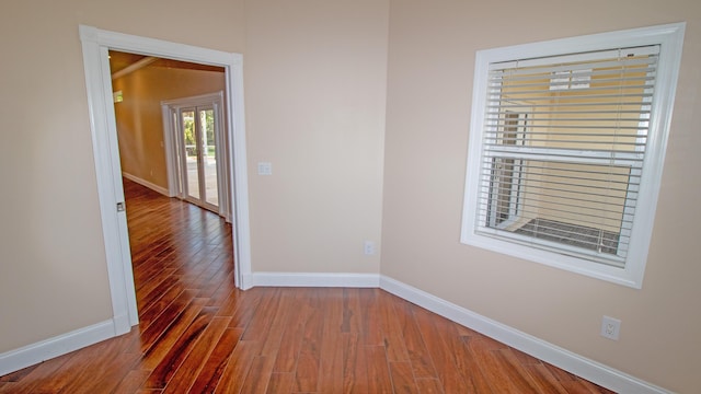 spare room with hardwood / wood-style flooring