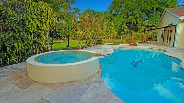 view of swimming pool featuring a patio and an in ground hot tub