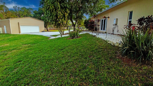 view of yard featuring an outbuilding and a garage