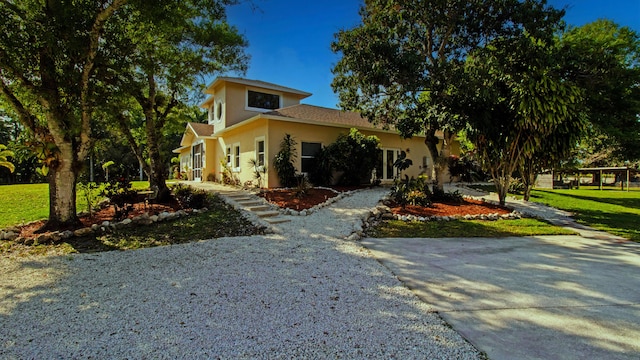 14717 11th Ter, Loxahatchee Groves, FL 33470 - view of front of house featuring driveway, stucco siding, and a front yard