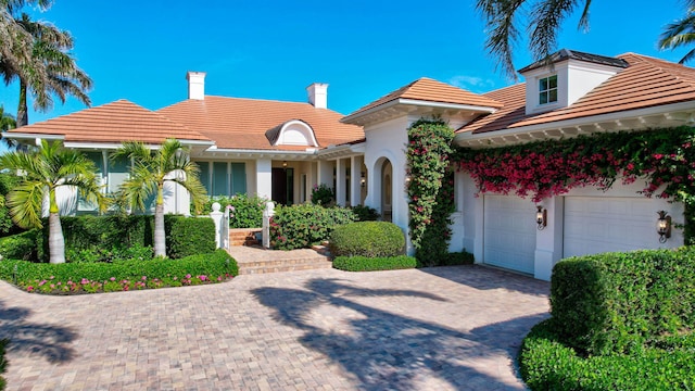 mediterranean / spanish-style house featuring a garage