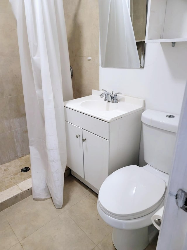 bathroom with tile patterned flooring, vanity, a shower with curtain, and toilet