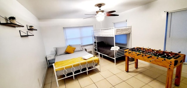 tiled bedroom featuring ceiling fan