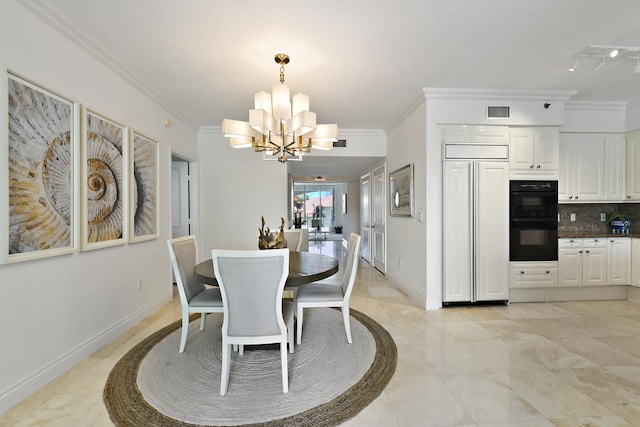 dining space featuring crown molding and a chandelier