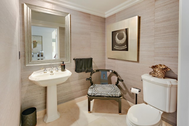 bathroom with crown molding, toilet, and tile patterned flooring