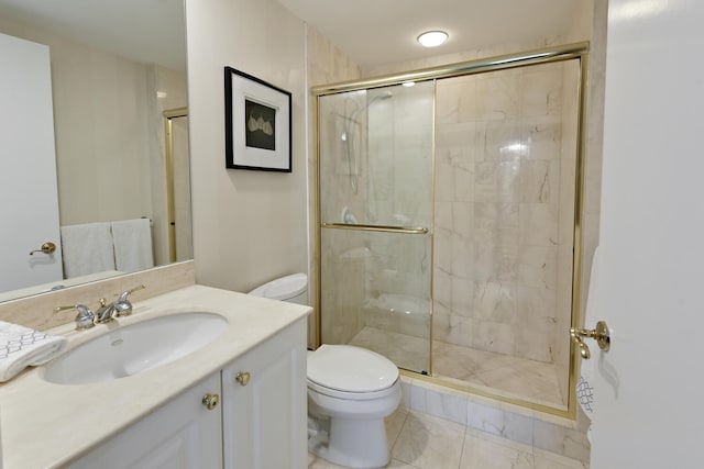 bathroom featuring vanity, a shower with shower door, and toilet