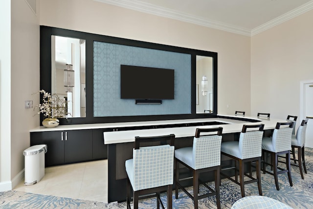 bar with light tile patterned flooring and ornamental molding