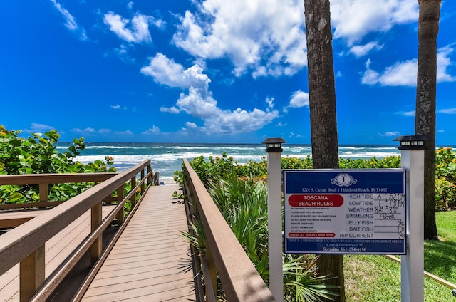 view of property's community featuring a water view and a view of the beach