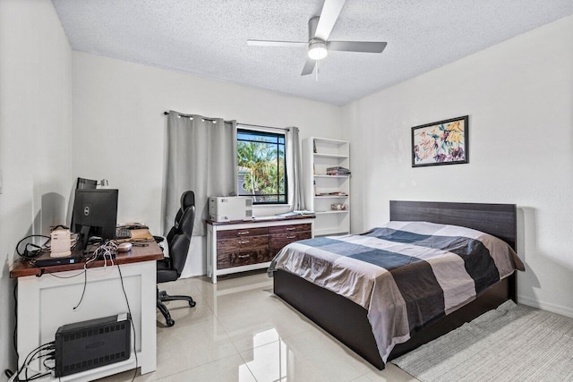 tiled bedroom with ceiling fan and a textured ceiling