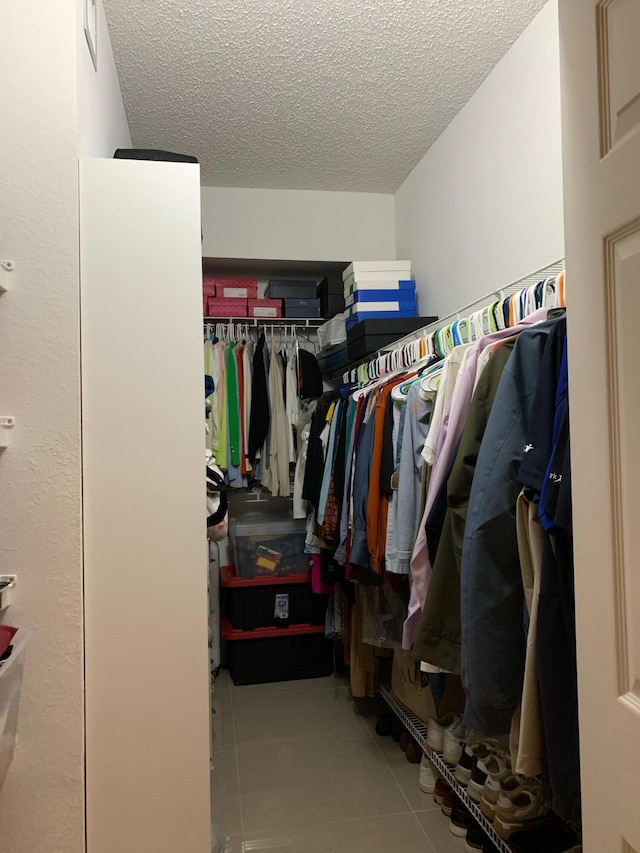 spacious closet featuring light tile patterned floors