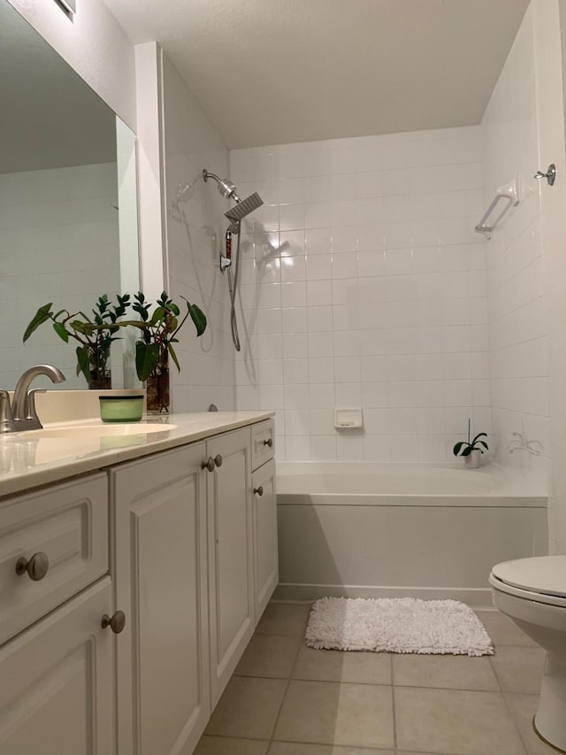 full bathroom featuring vanity, toilet, tiled shower / bath combo, and tile patterned flooring